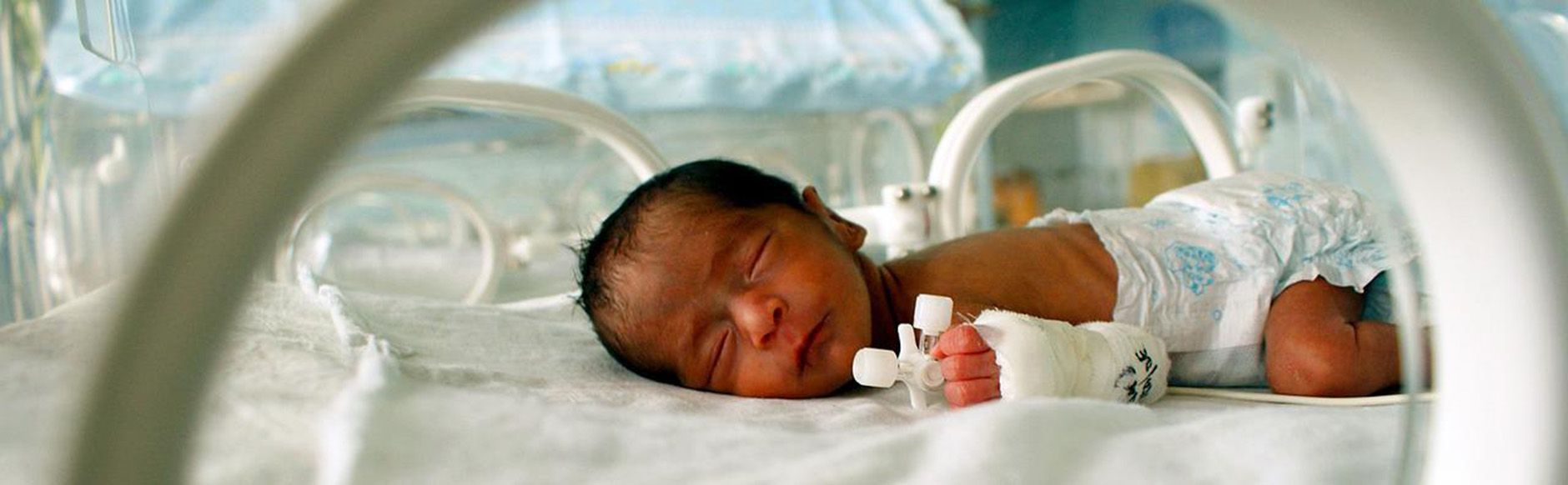A newborn in an incubator